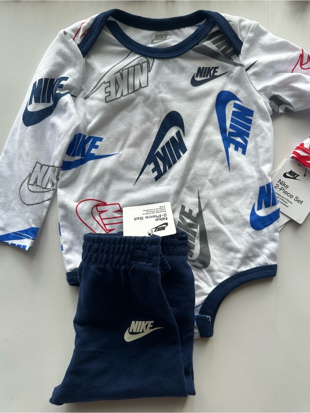 Nike White Bodysuit & Navy Pants Set with Blue, Gray, Red Logos